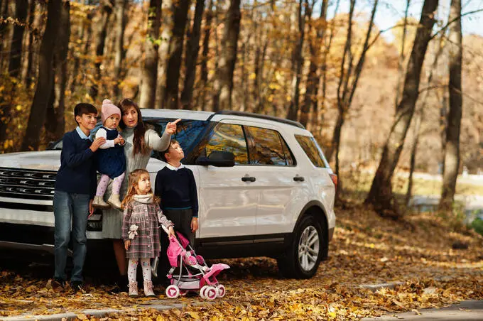 mother-stand-near-white-suv-car-